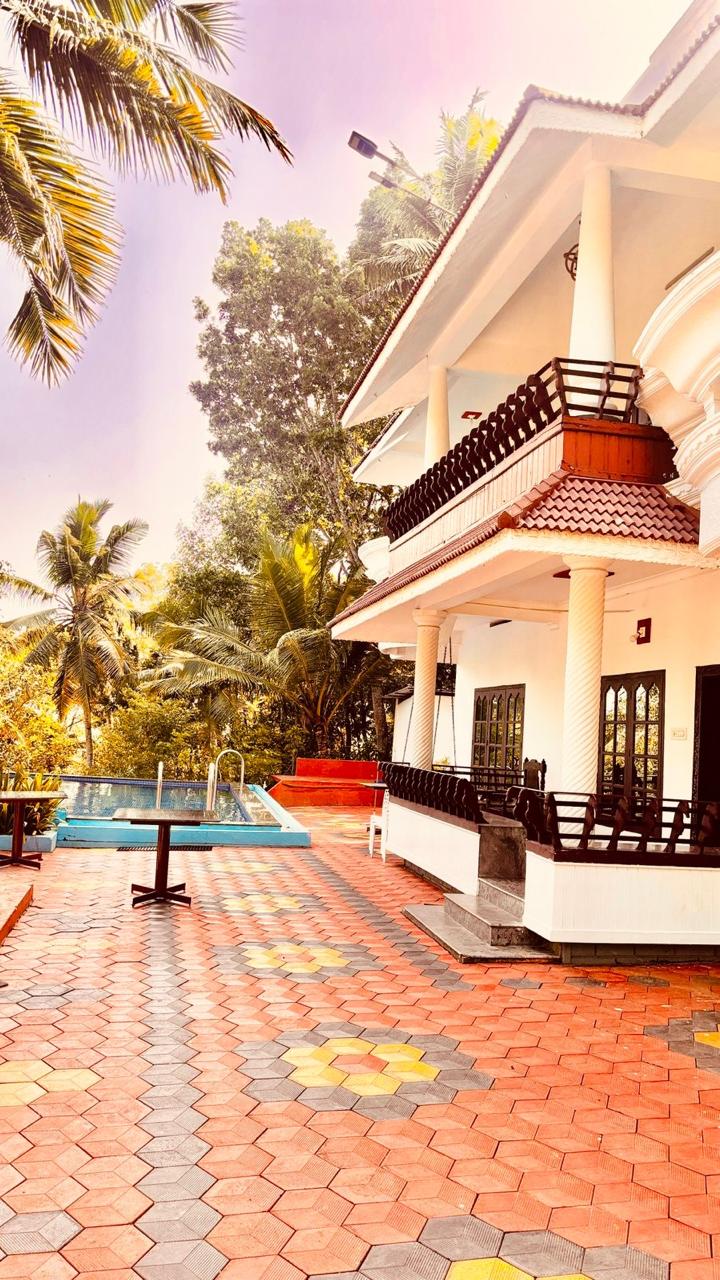 Swimming pool and sunlit courtyard at Whispering Kera