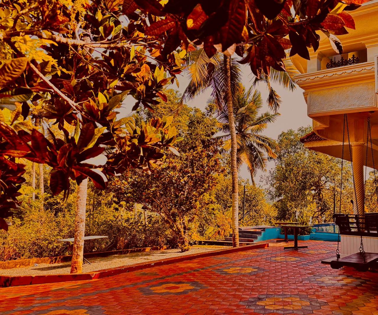 Tropical garden surrounding Whispering Kera guest house in Poovar