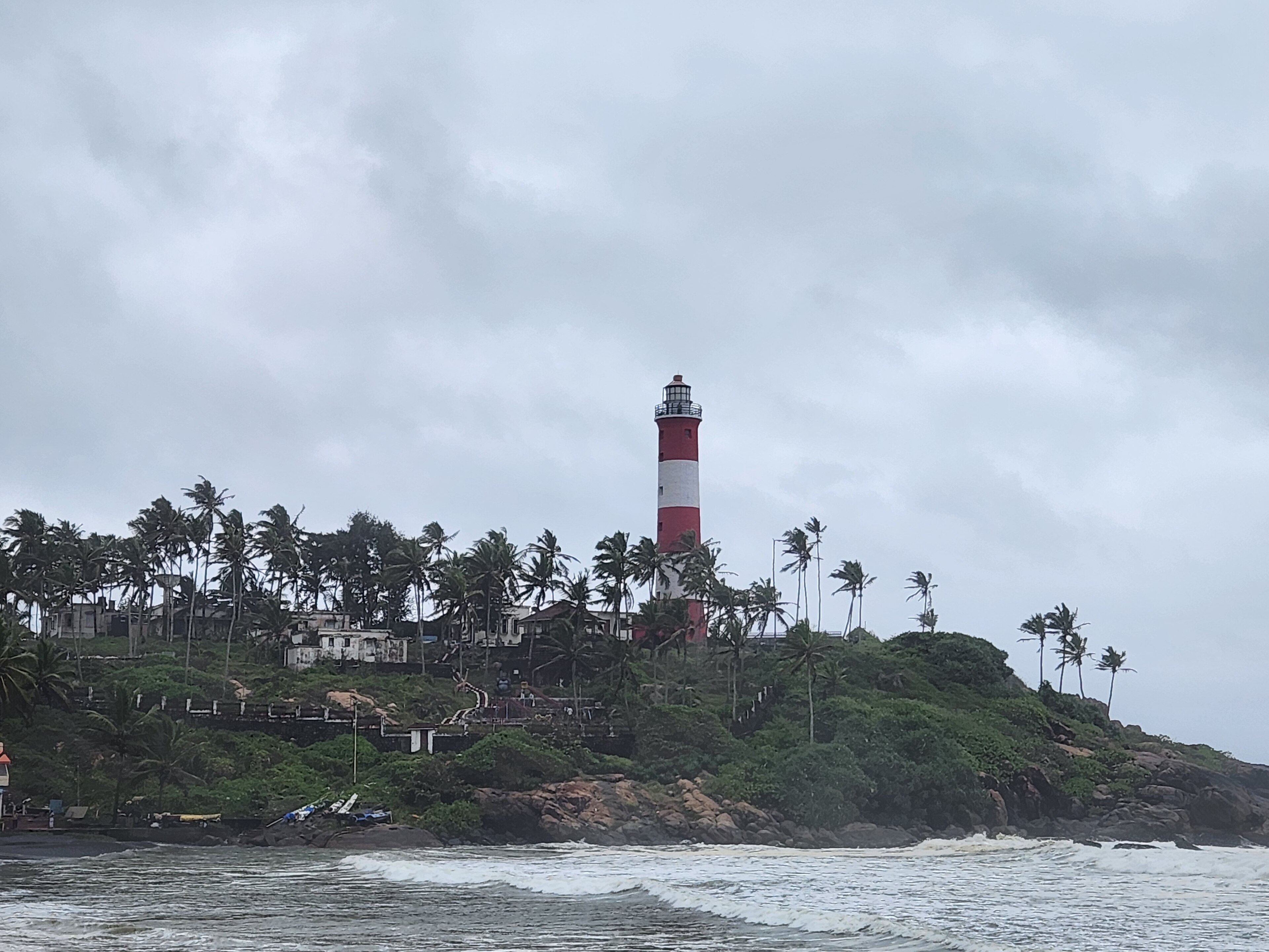 Lighthouse Beach and the red-and-white Vizhinjam lighthouse at Kovalam