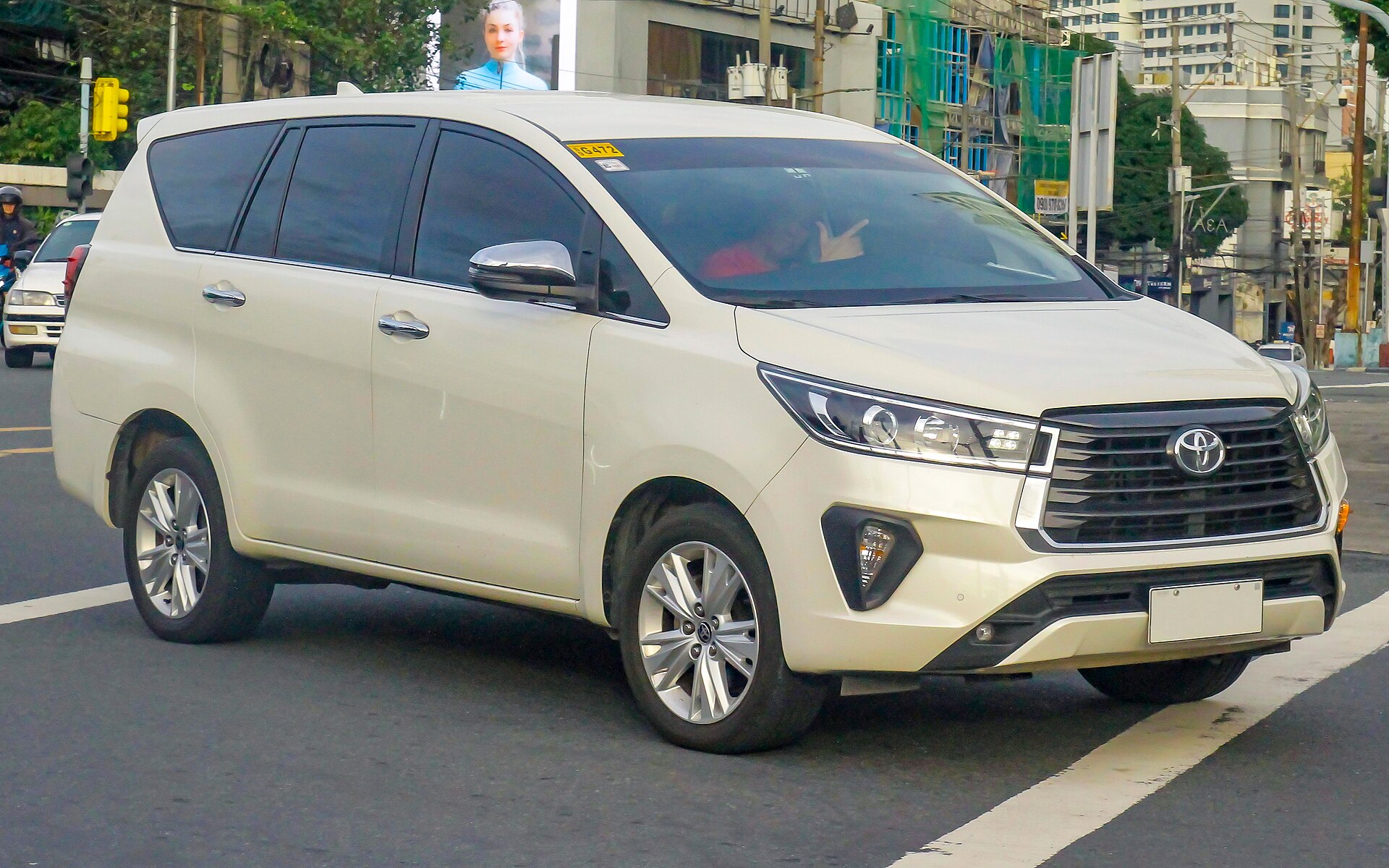 White Toyota Innova representative of the seven-seater AC cab fleet